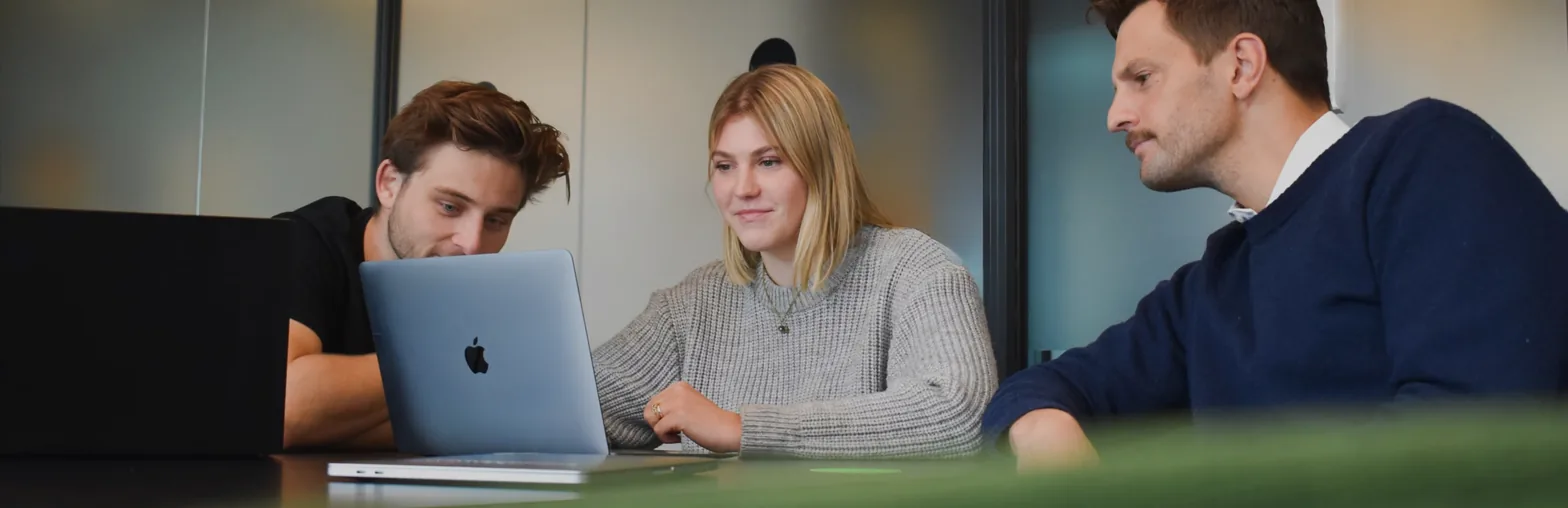 Designers and developers working together at a laptop