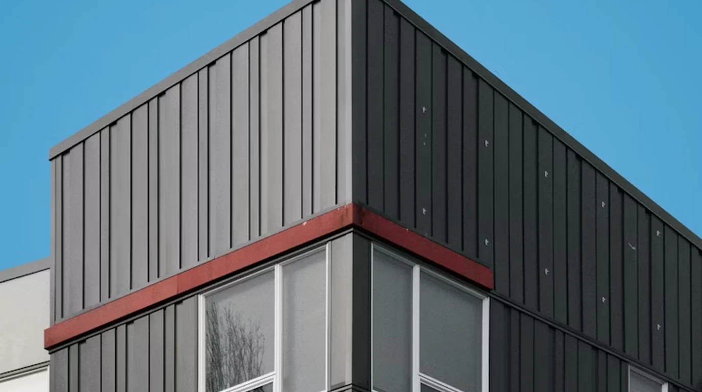 A modern clad building under a blue sky