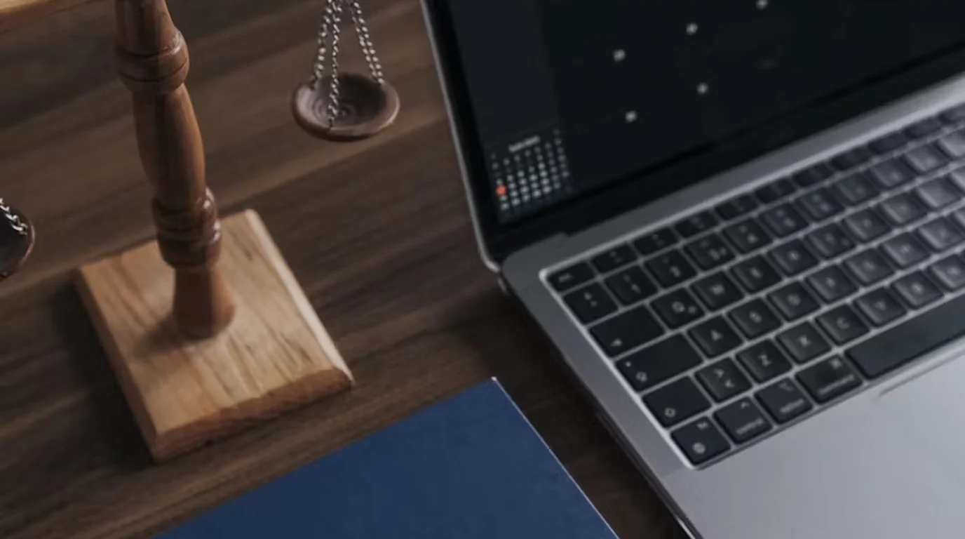 A laptop and a gavel on a desk